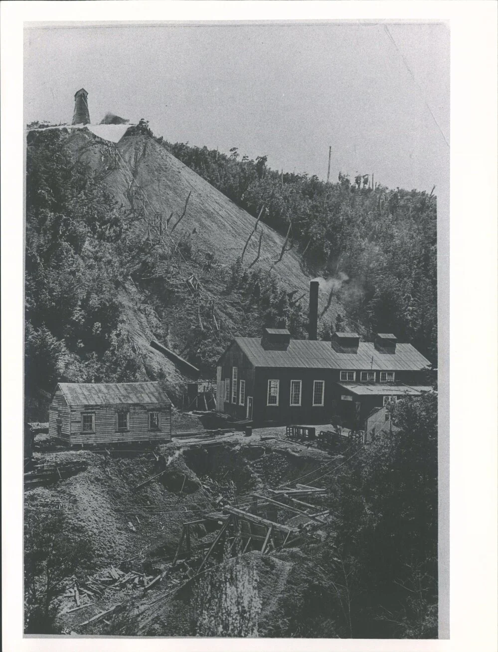 View of winding engine shed, rope & poppet head above mine shaft