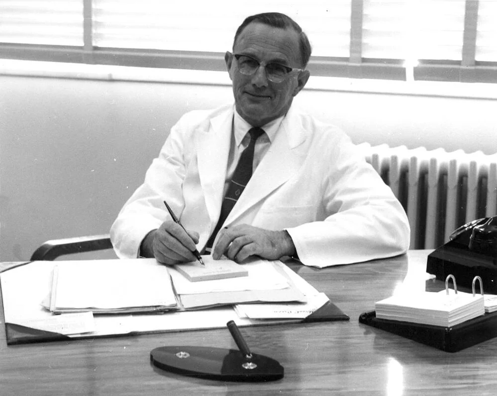 Sir John Walsh at his desk