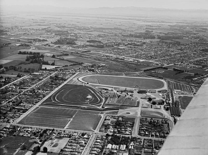 Aerial Oblique. Horse Racing. Addington Raceway for Harness Horse Racing also known as Trotting, With the Agricultural and Pastoral |( A & P ) Showgrounds on the Right. Lincoln Road is Across the bottom. with the Railway and Blenheim Road Across the Top. Addington, Christchurch, Canterbury, New Zealand.