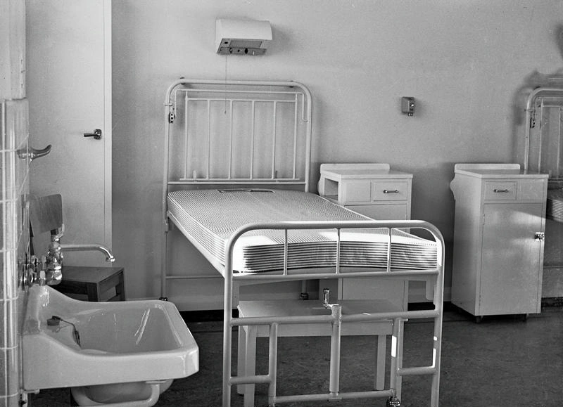 Christchurch Public Hospital, Interior. Patient Care. Bed and Locker in a Ward Containing a Number of such Beds. There is Long Step under the Bed , a Light above. a Bell Press to call a Nurse and An Oxygen Outlet on the Wall between the Beds. Christchurch, Canterbury, New Zealand.