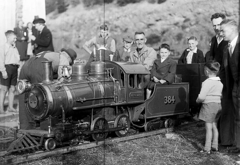 Children enjoying a model steam railway train, Christchurch, Canterbury, New Zealand.