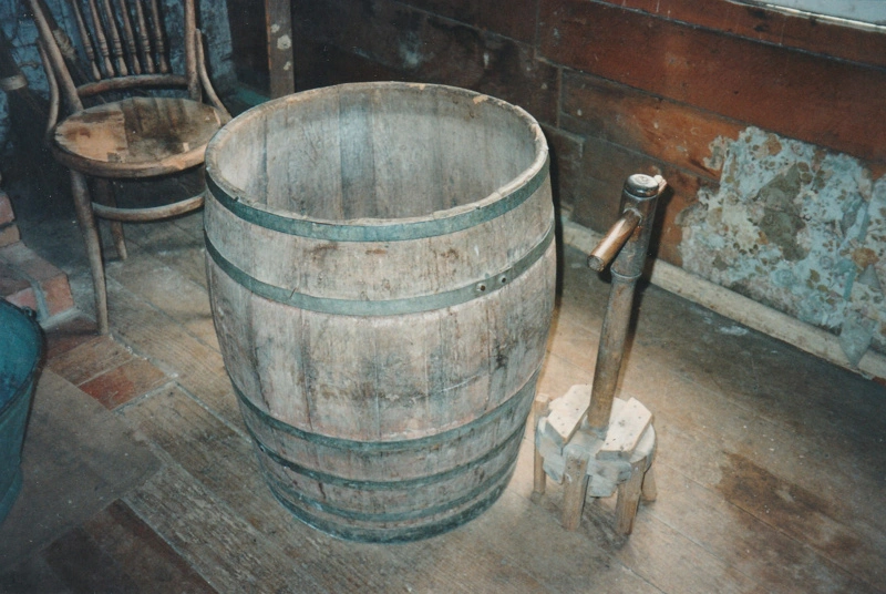 Dolly tub and dolly tub plunger at Howick Historical Village used for washing clothes.