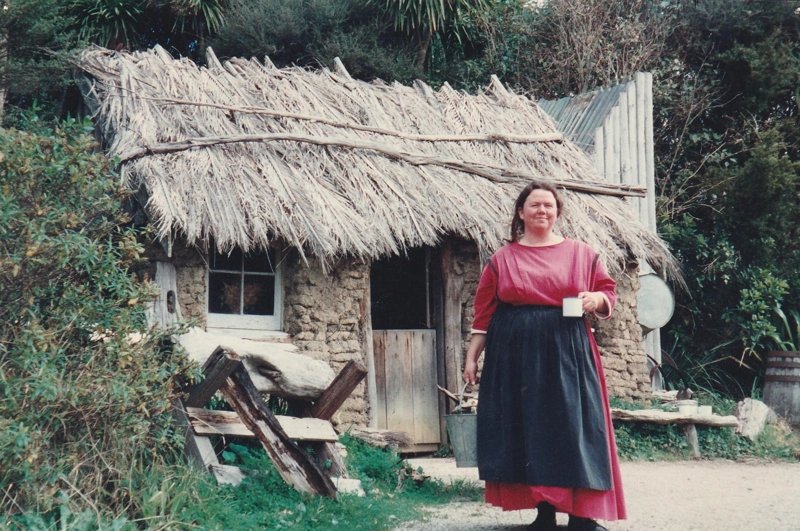 Debbie Benson in costume as Maggie Thompson in front of the sod cottage on a Live Day at HHV.