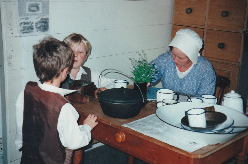 Jane Martinson and her sons, Sam and Richard in costume, in Briody's cottage in Howick Historical Village.