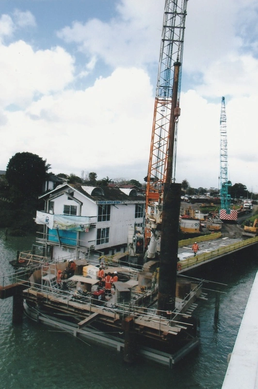The new Tamaki River bridge which will become a bus lane, under construction. The casissin for the bridge foundation is in the foreground.