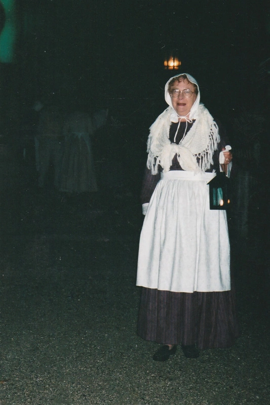 A guide in costume, holding a candle lamp during a Candle lit tour at Howick Historical Village, 27 May 2003.