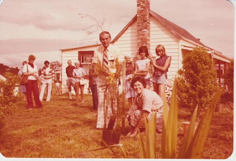 John Litten and Eileen Martensen planting a Kowhai tree