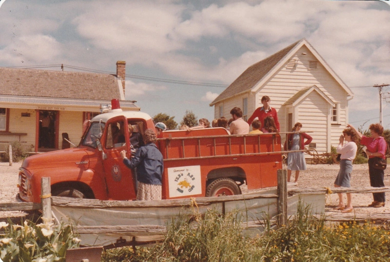 People looking at a vintage truck advertising the 1ZB & ASB 1080 club in Howick Historical Village during the 1080 Gala in October 1983.