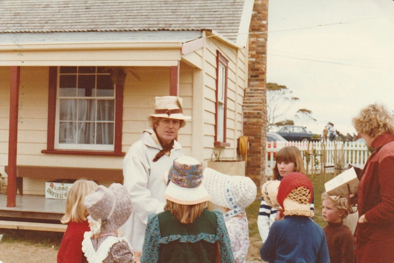 Alan la Roche (in costume) with a group of children outside Brindle Cottage In Howick Historical Village on a Live Day.