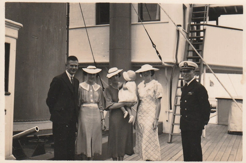 Amy and Geoff Fairfield and others with a naval officer on board a ship.