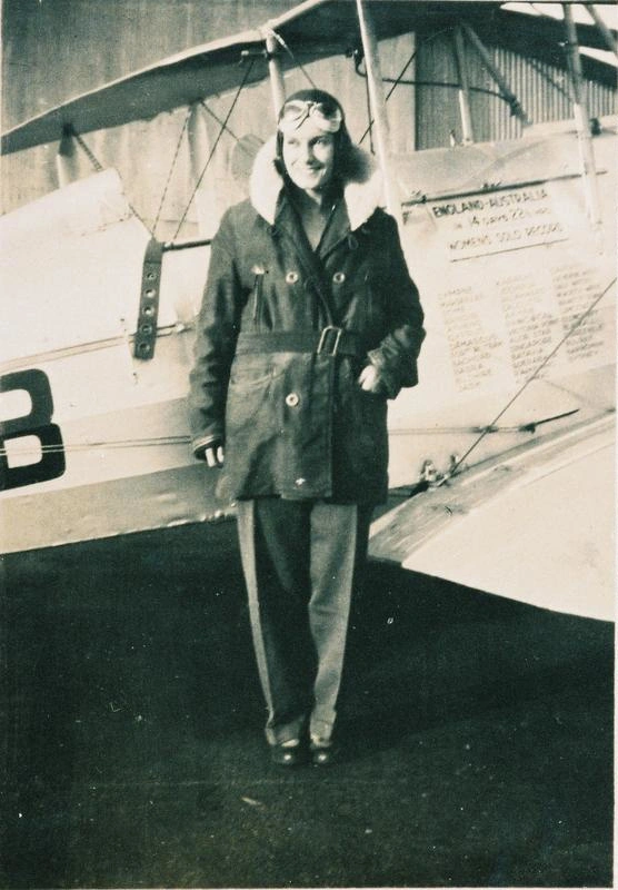 Jean Batten standing next to her plane