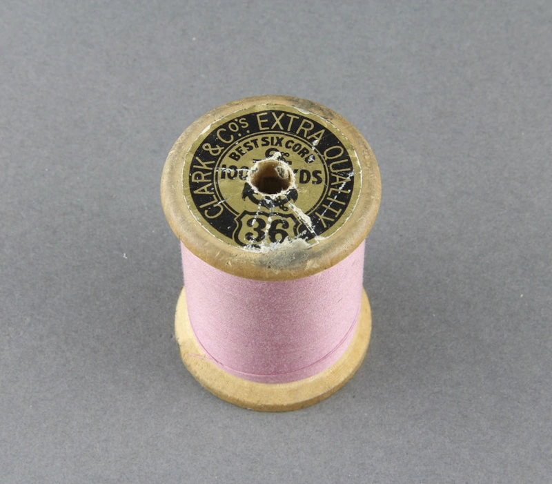 Sewing thread on spool, pink cotton