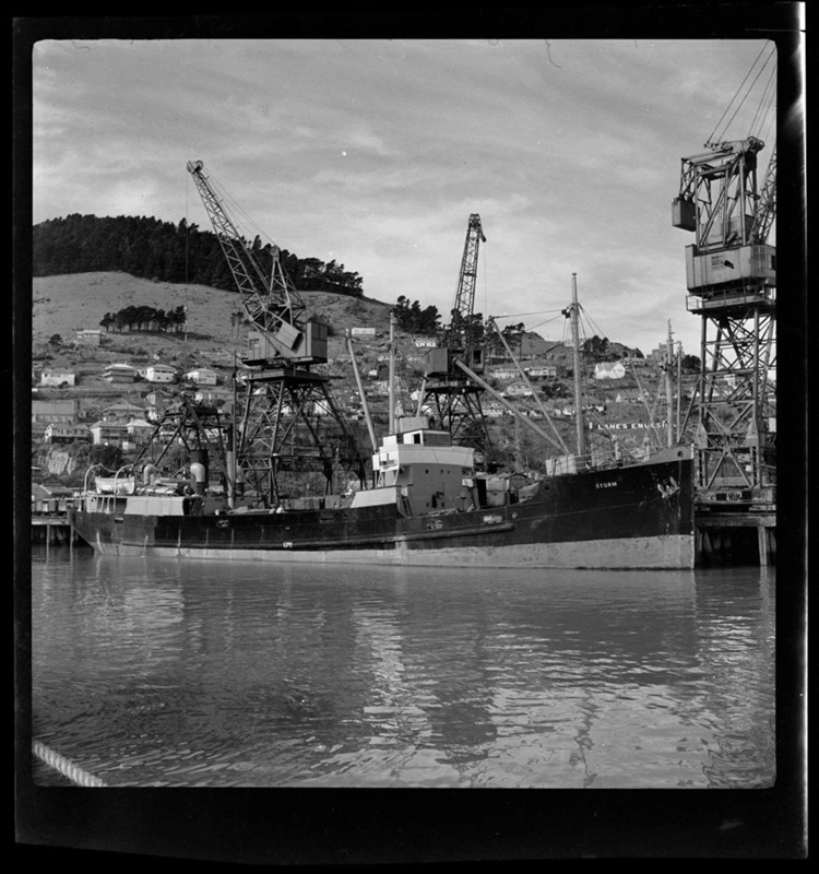 Ship with "STORM" written on the bow in Lyttelton Port. Timeball Station can be seen in the background.