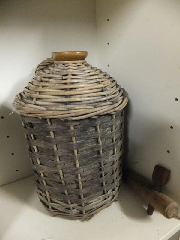 Demijohn, stoneware jar encased in a cane basket