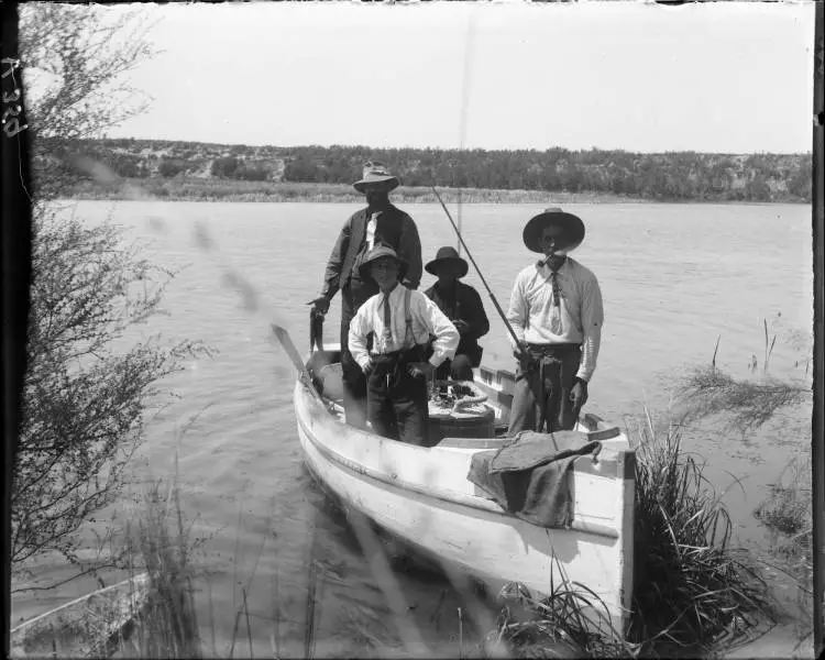 Four men in a boat on the Waikato River, Broadlands, 1907