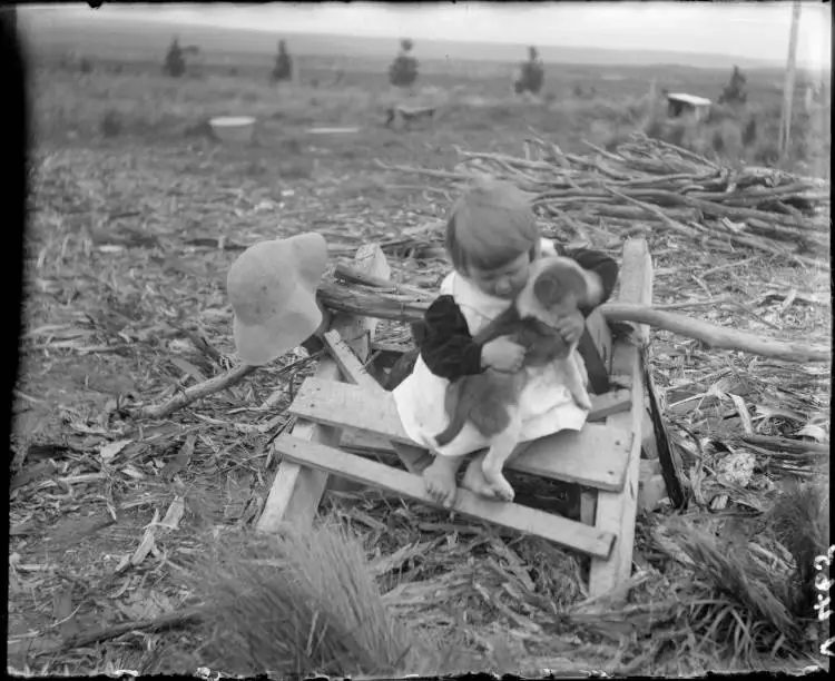 Young girl with a puppy at Broadlands, 1910