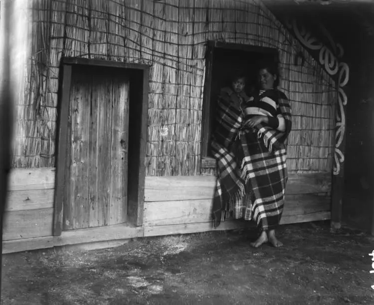 Woman and baby outside a whare at Ohaaki, Reporoa, 1909