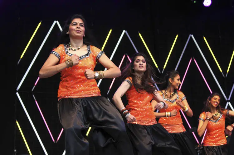 Groups doing Bollywood dancing.