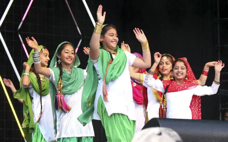 Group of girls doing Bhangra dancing.