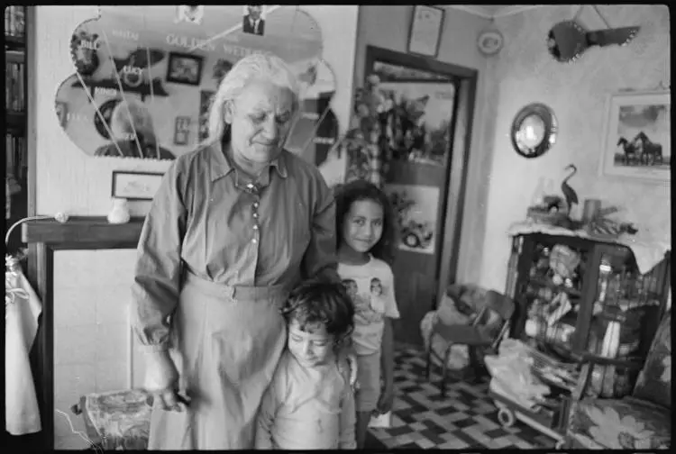 Taukiri Neho and her mokopuna in their home, Te Hāpua, 1977