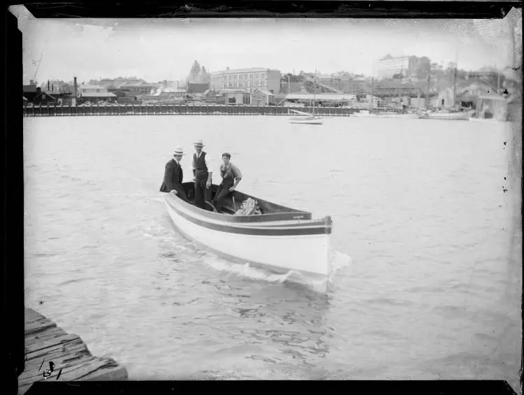 Three men in a launch, Freemans Bay