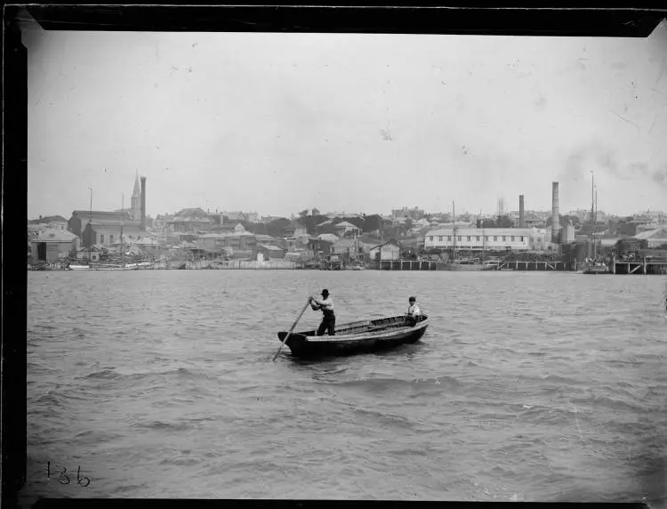 Two men rowing a dinghy in Freemans Bay