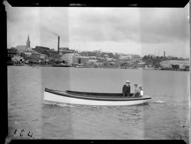 Three men in a launch, Freemans Bay