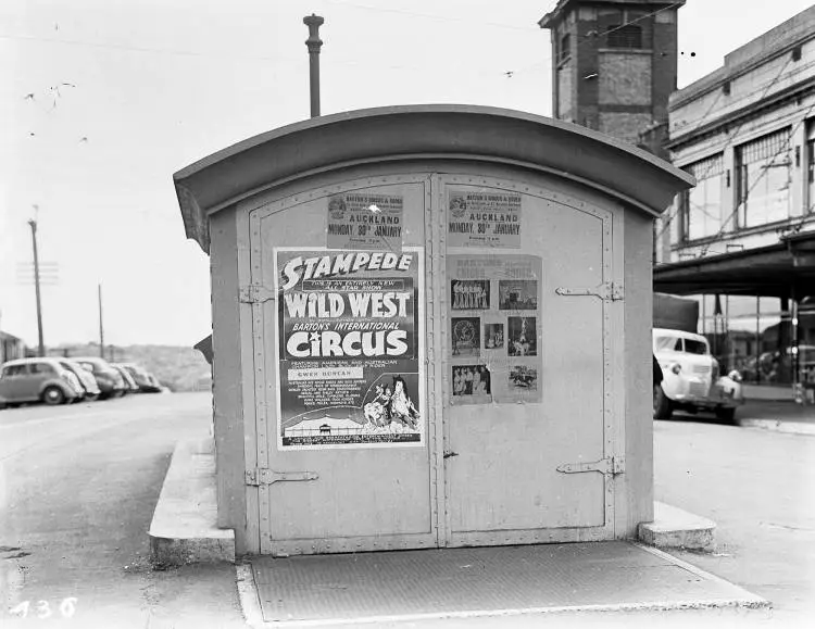 Posters on public toilets, Beresford Street, 1950