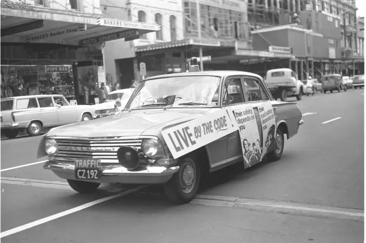 Car decorated with road safety posters, 1965