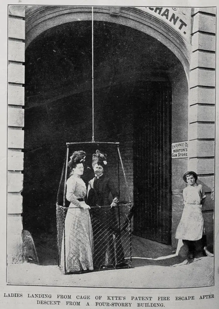 Ladies landing from a cage of Kyte's patent fire escape after descent from a four storeyed building