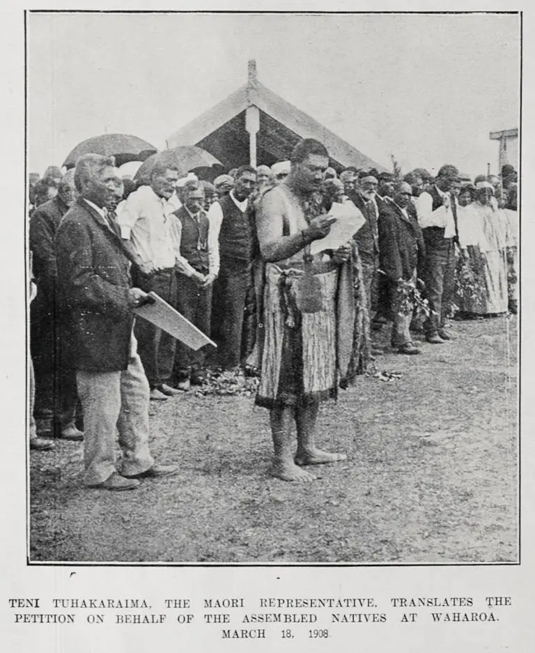 TENI TUHAKARAIMA, THE MAORI REPRESENTATIVE, TRANSLATES THE PETITION ON BEHALF OF THE ASSEMBLED NATIVES AT WAHAROA, MARCH 18, 1908