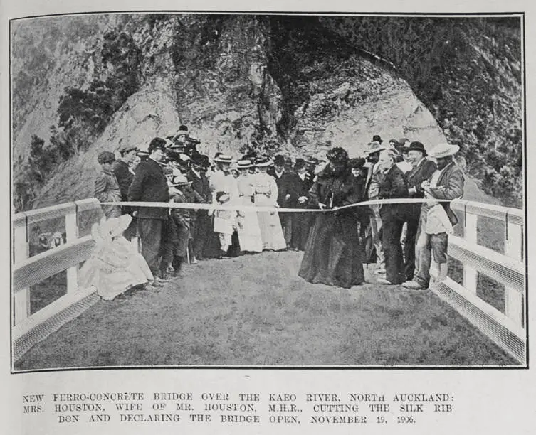 NEW FERRO-CONCRETE BRIDGE OVER THE KAEO RIVER. NORTH AUCKLAND: MRS. HOUSTON, WIFE OF MR. HOUSTON, M.H.R., CUTTING THE SILK RIBBON AND DECLARING THE BRIDGE OPEN, NOVEMBER 19. 1906