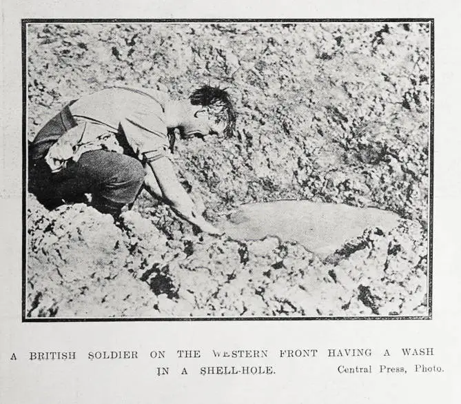 A British soldier on the Western Front having a wash in a shell-hole