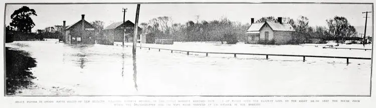 Heavy floods in Otago, South Island of New Zealand. Allanton Railway Station, in the Taieri district, showing five feet of water over the railway line.