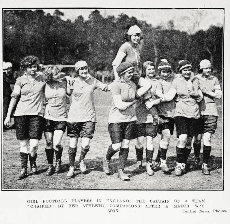 Girl football players in England: the captain of a team chaired by her athletic companions after a match was won