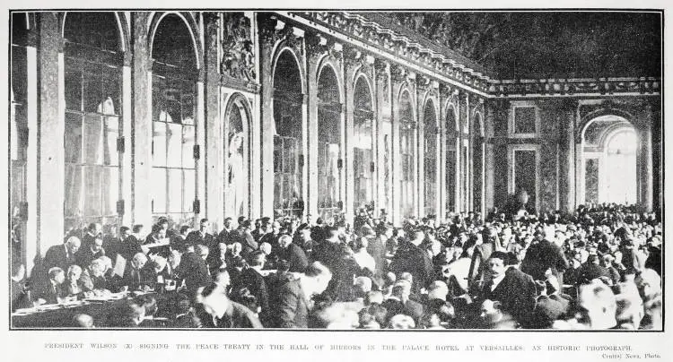 President Wilson (x) signing the peace treaty in the Hall of Mirrors in the Palace Hotel at Versailles: an historic photograph