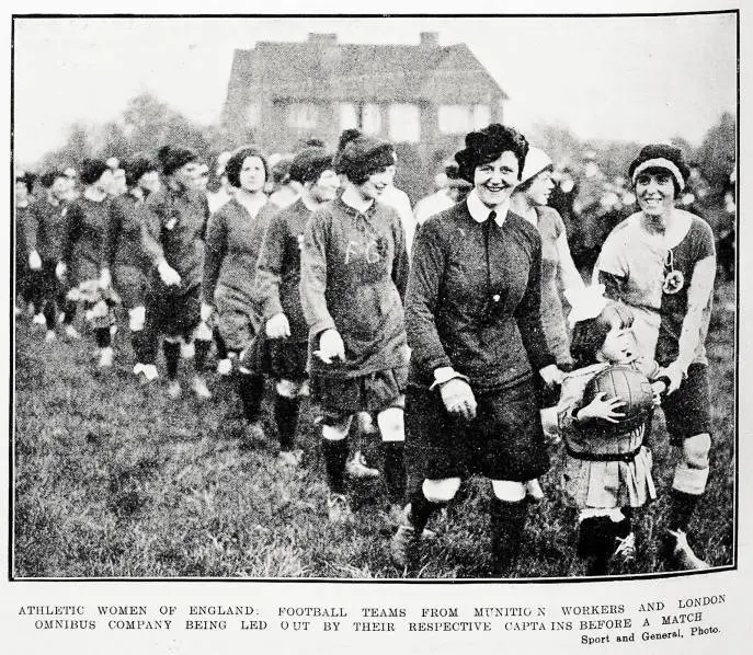 Athletic women of England: football teams from Munition Workers and London Omnibus Company being led out by their respective captains before a match