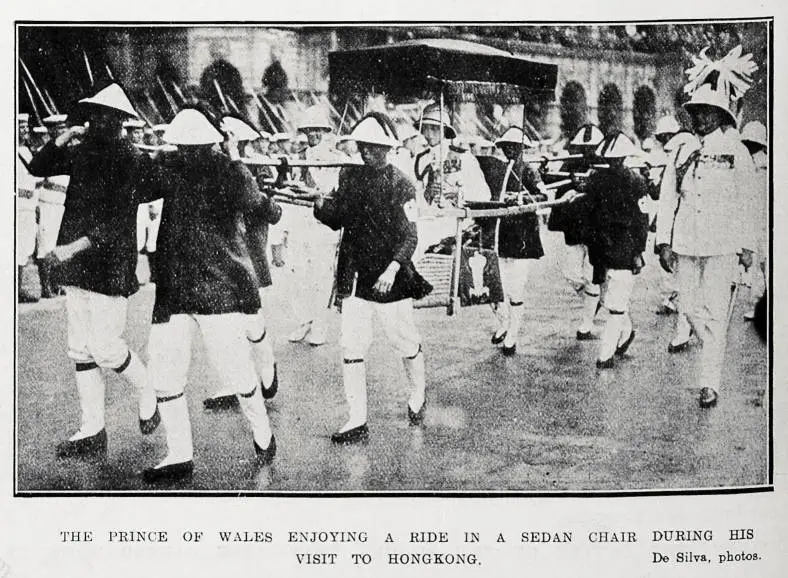 The Prince of Wales enjoying a ride in a sedan chair during his visit to Hong Kong