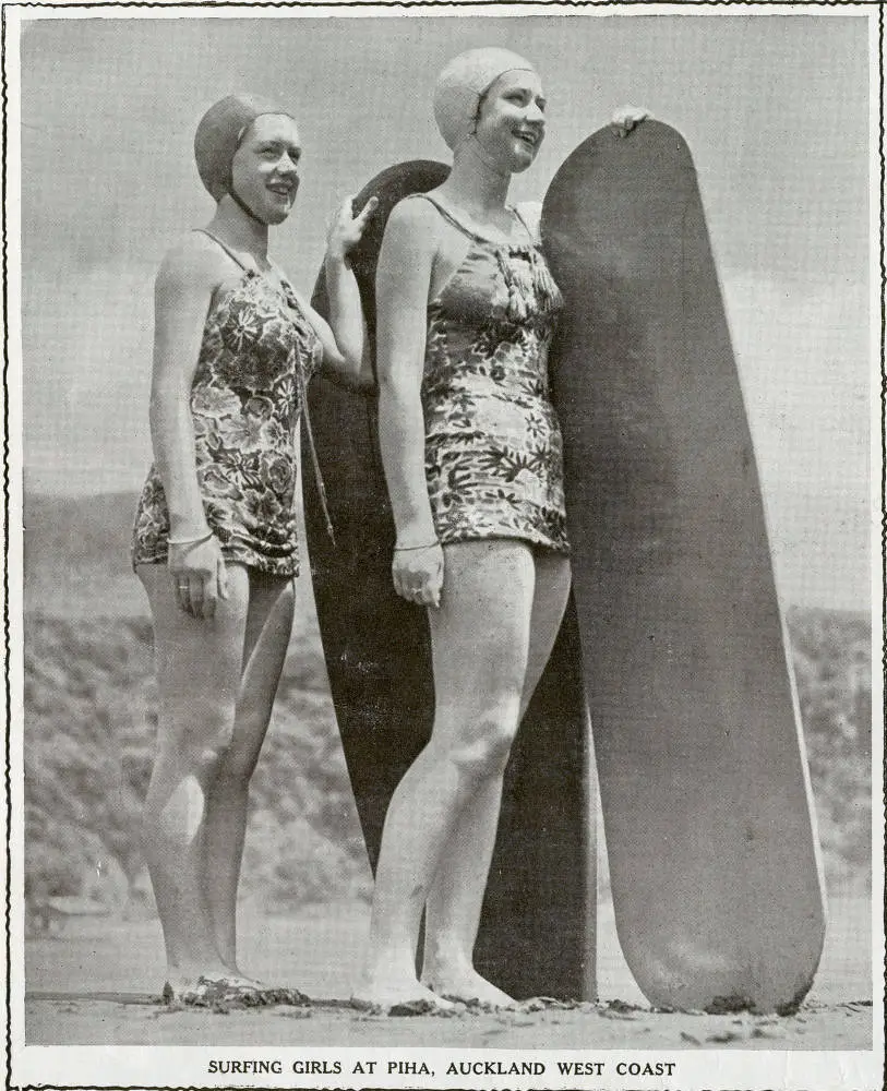 Surfing girls at Piha, Auckland west coast