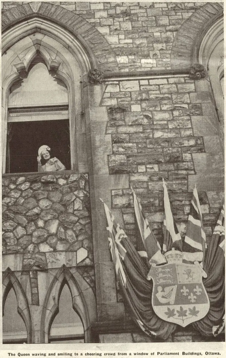 The Queen waving and smiling to a cheering crowd from a window of Parliament Buildings, Ottawa