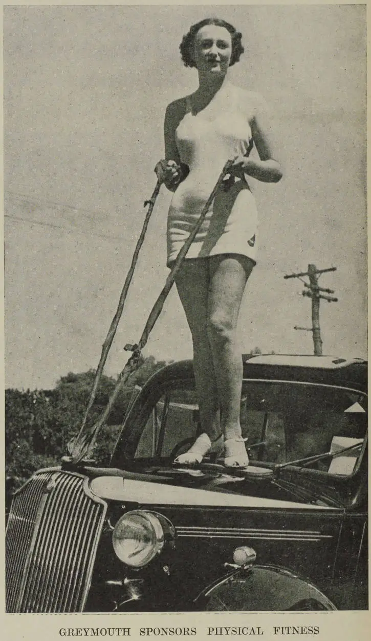 Miss Kathleen Thompson on the bonnet of a car in Greymouth as part of a physical fitness campaign