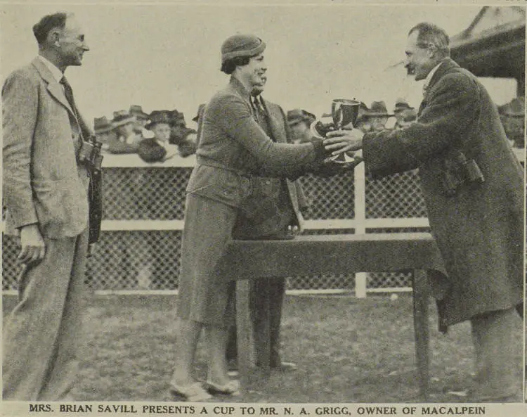 Mrs. Brian Savill presents a cup to Mr. N. A. Grigg, owner of Macalpein at the Washdyke Racecourse in Timaru