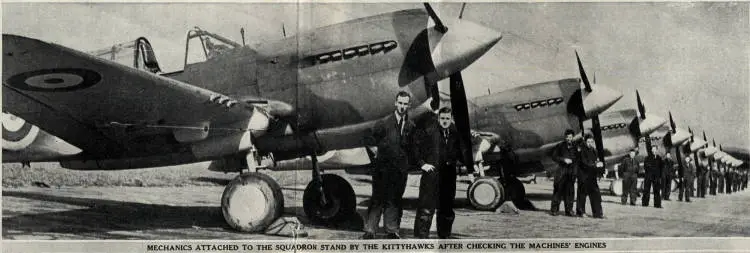 Mechanics attached to the squadron stand by the Kittyhawks after checking the machines' engines