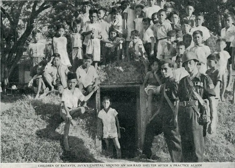Children of Batavia, Java's capital around an air-raid shelter after a practice alarm