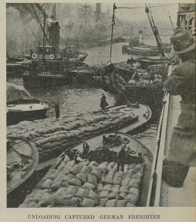 Unloading captured German freighter