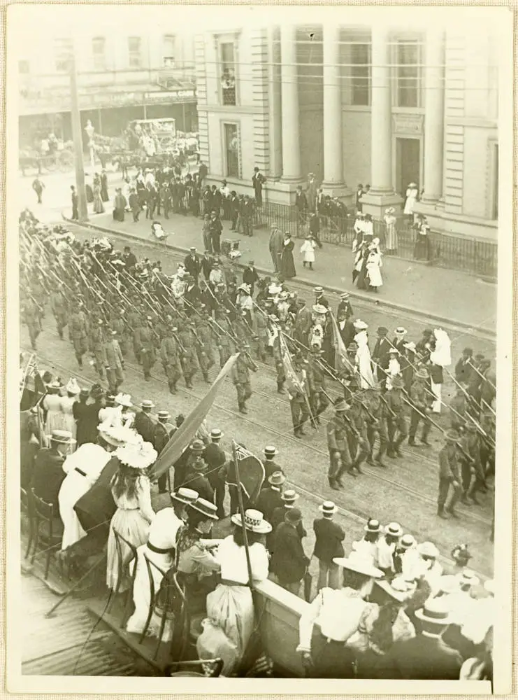Crowds watching a military parade on Queen Street