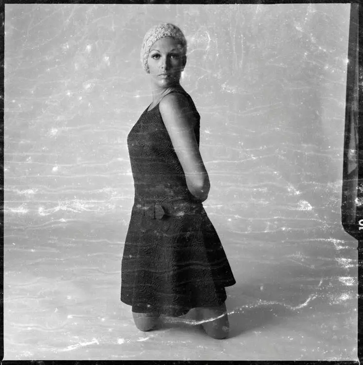 Model kneeling in a photography studio