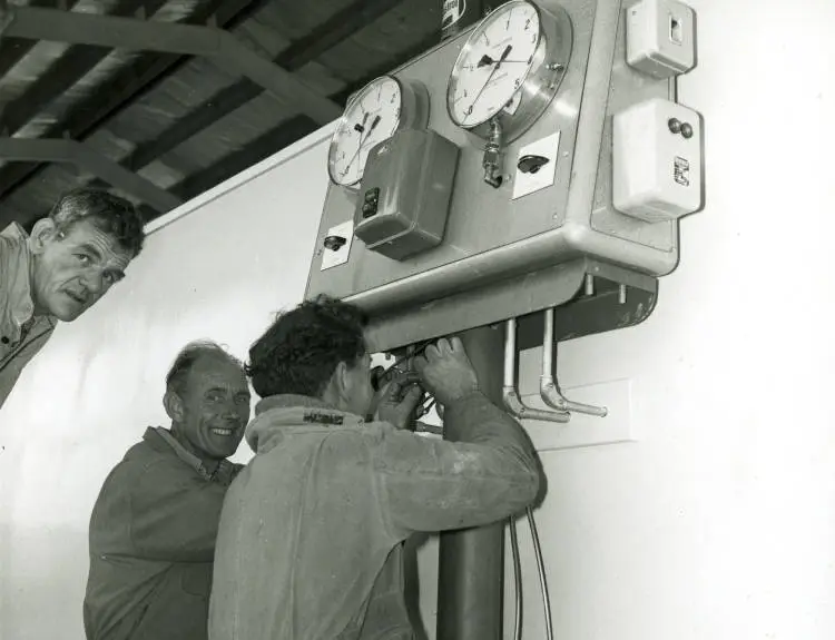 Men working at North Shore Vehicle Testing Station.