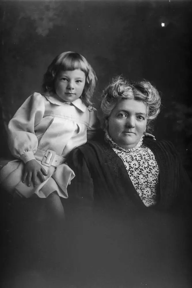 Mrs Mullins seated with a boy, 1909