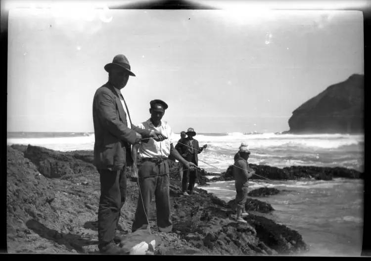 Fishing from the rocks, O'Neills Bay, Bethells Beach.